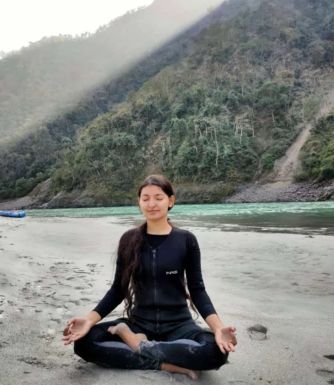 Yoga meditation by the river in Rishikesh