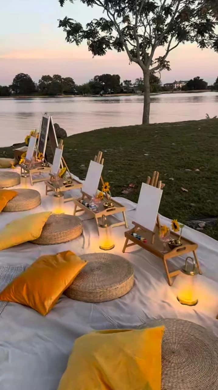 Riverside weekend art retreat setup in Rishikesh with canvases, cushions, and creative materials